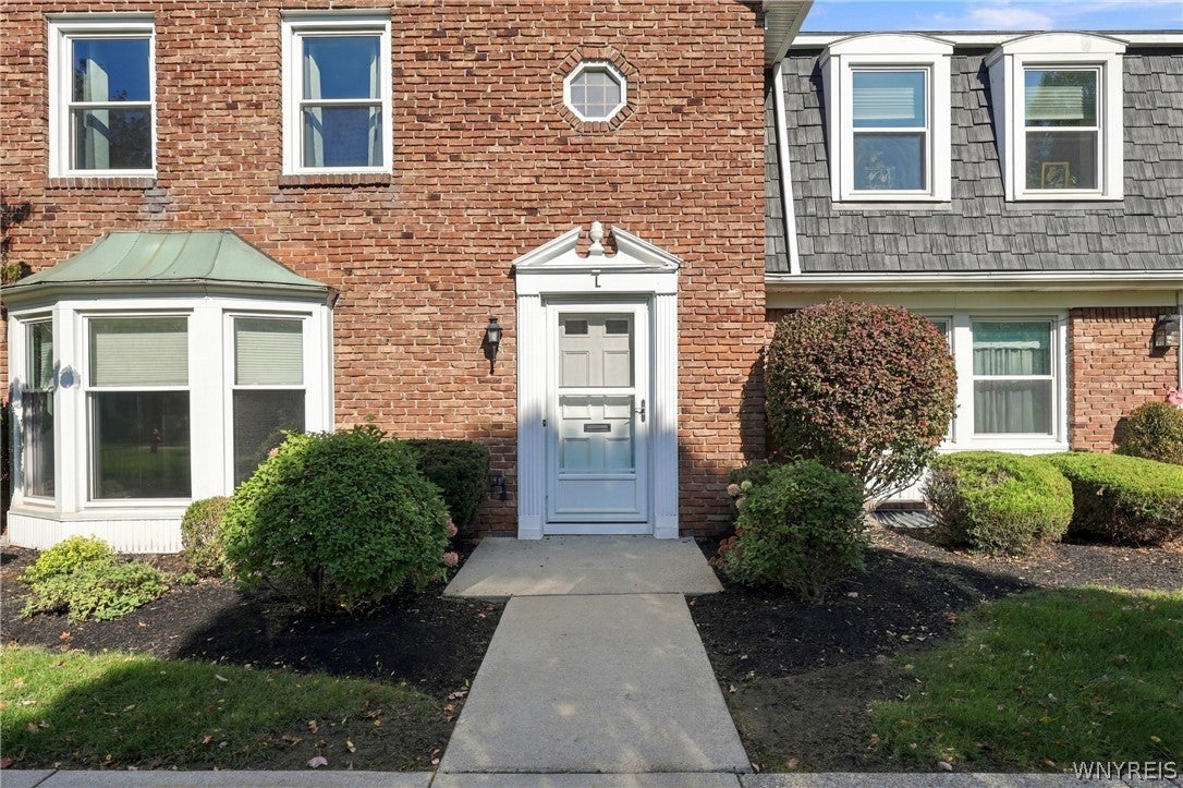 End-unit Williamsville NY condo for sale at 85 Oakbrook Drive with brick exterior and bay window